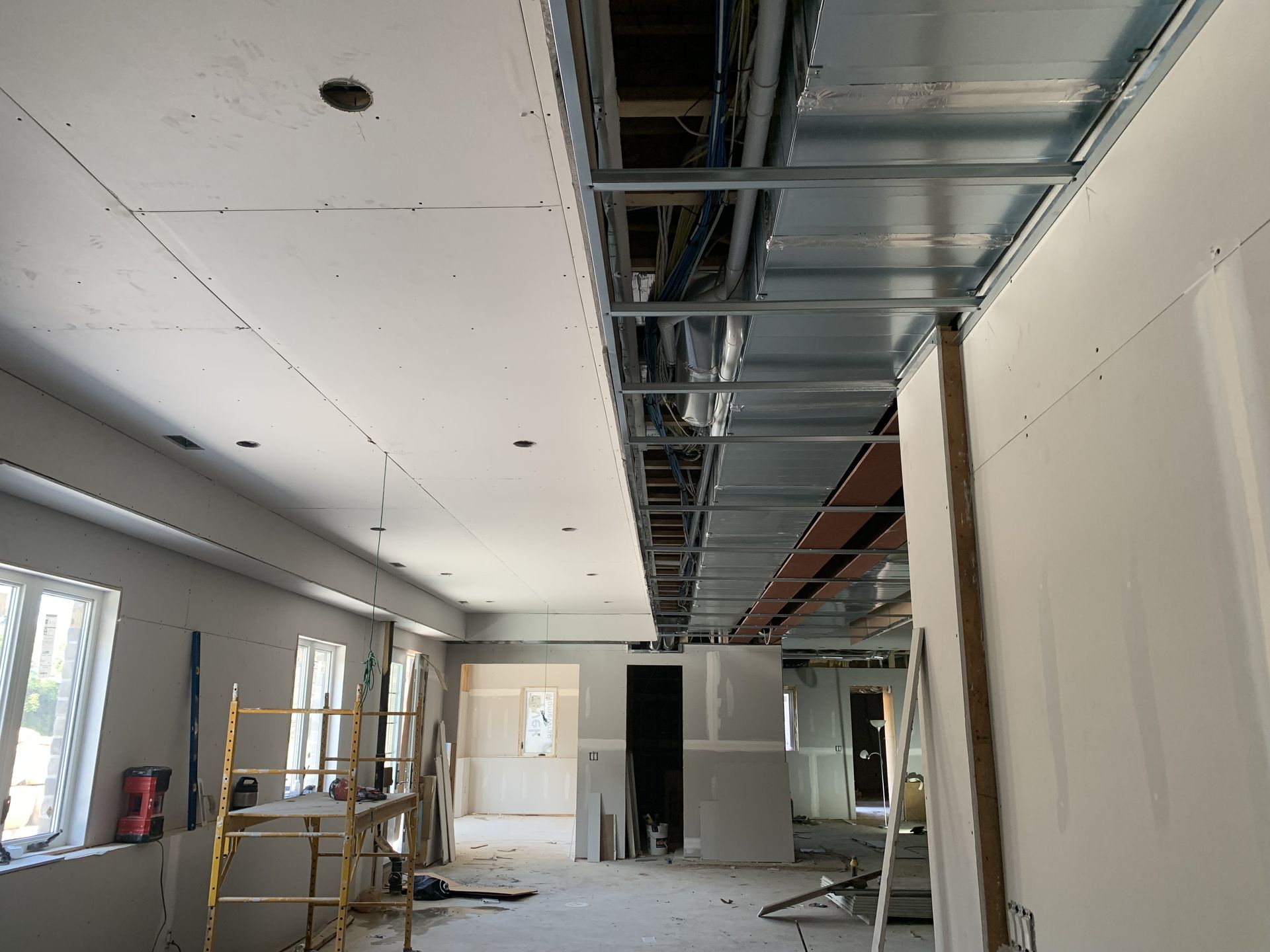 A large room with a ceiling that is being built