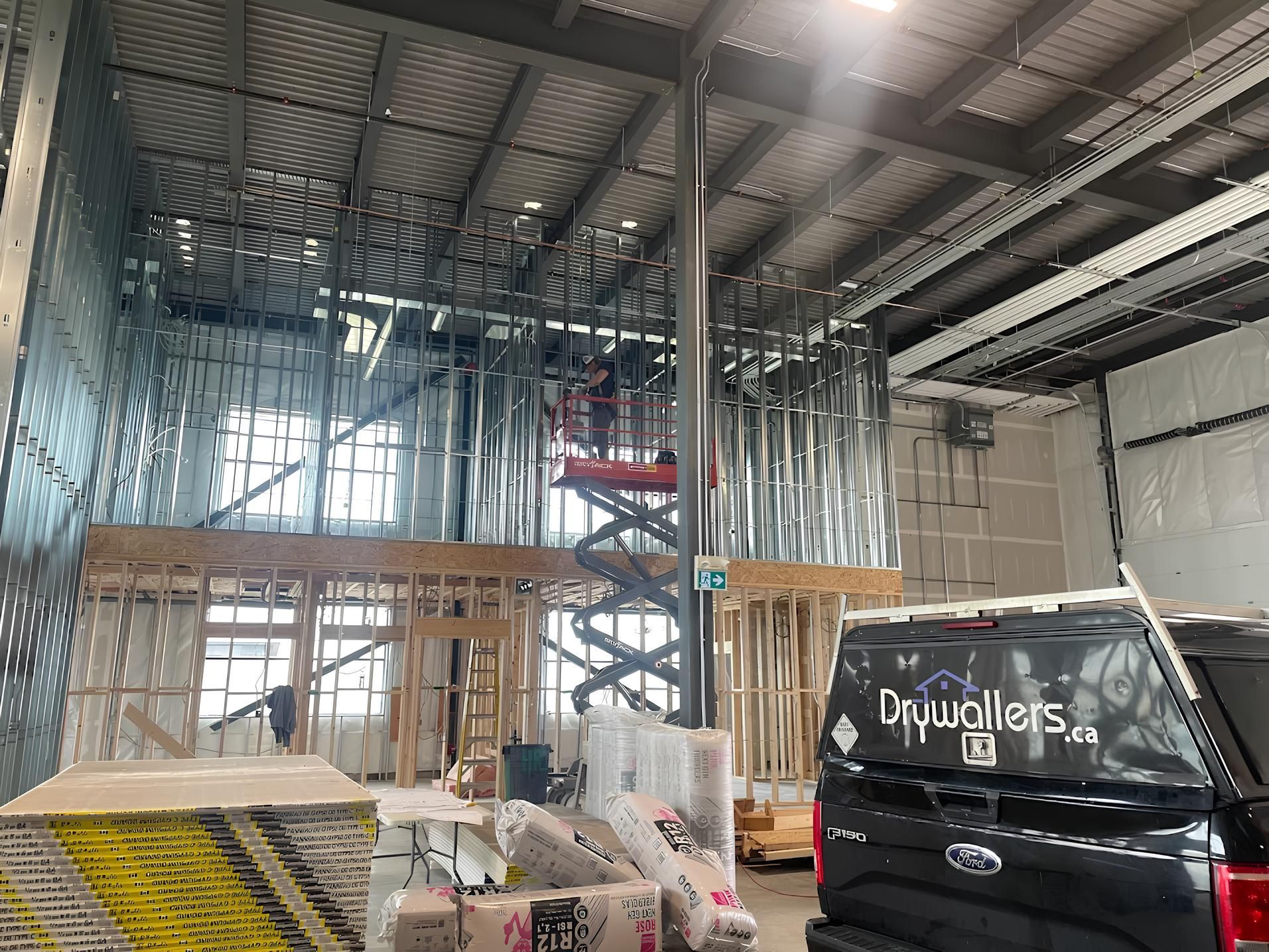 A truck is parked in front of a building under construction.