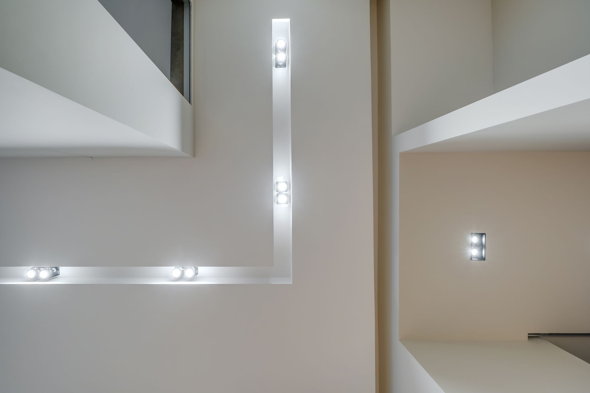 A white wall with a few lights on it