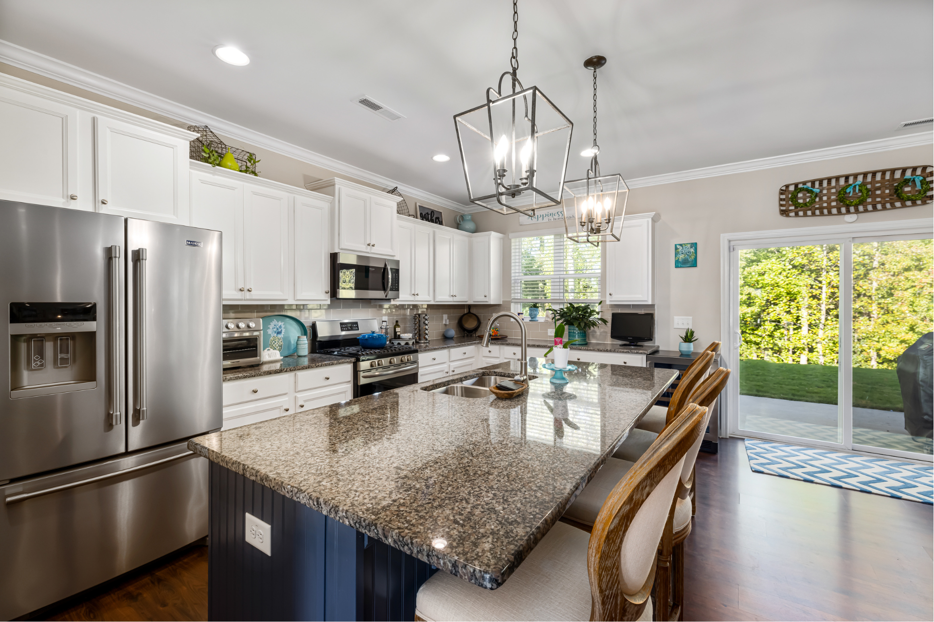 clean kitchen with granite counter tops and white cabinets.