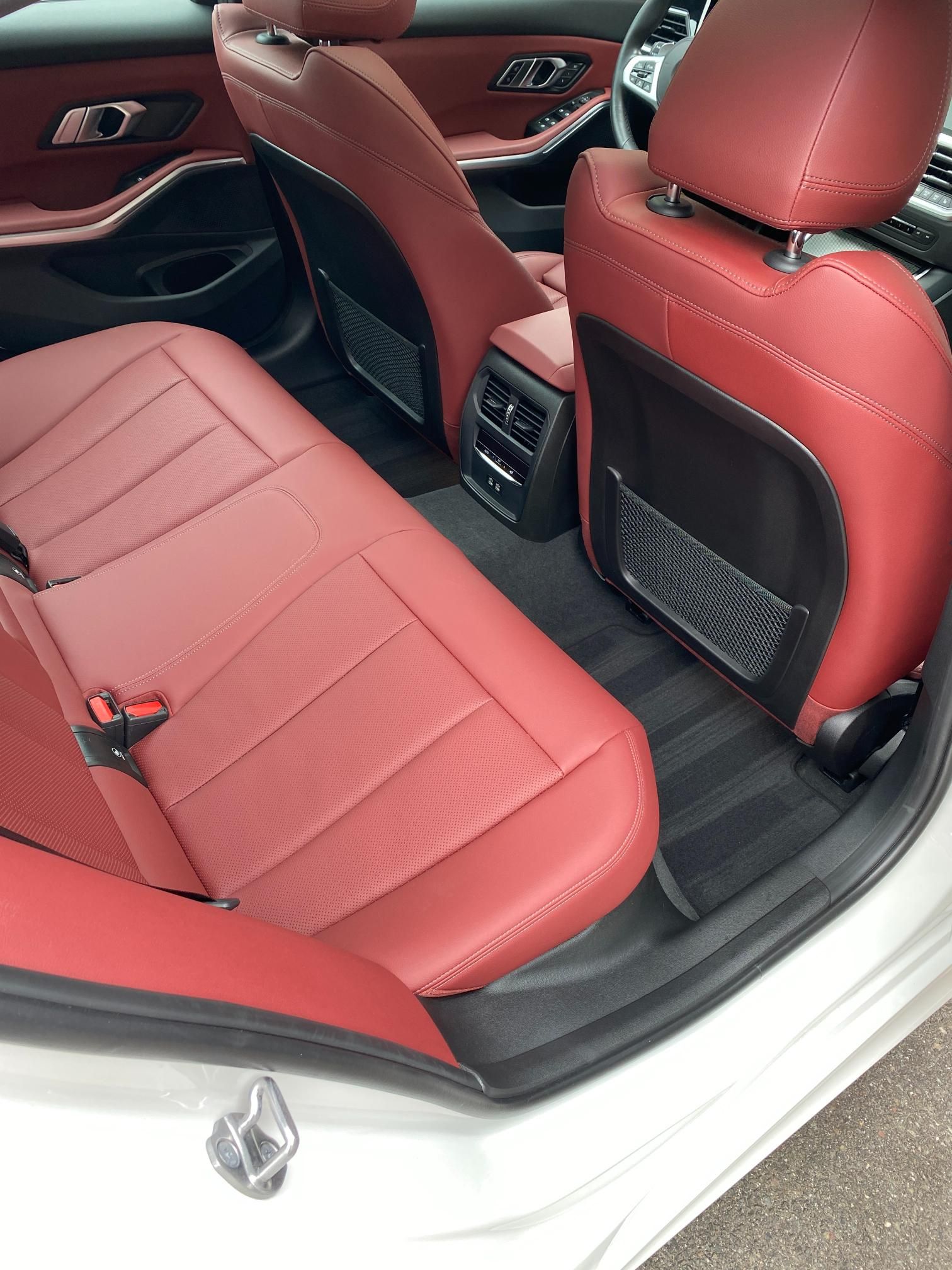 Clean red leather backseats of BMW 3-series