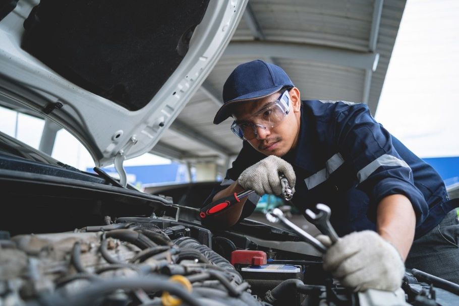 Roadside mechanic repairing a broken-down car.