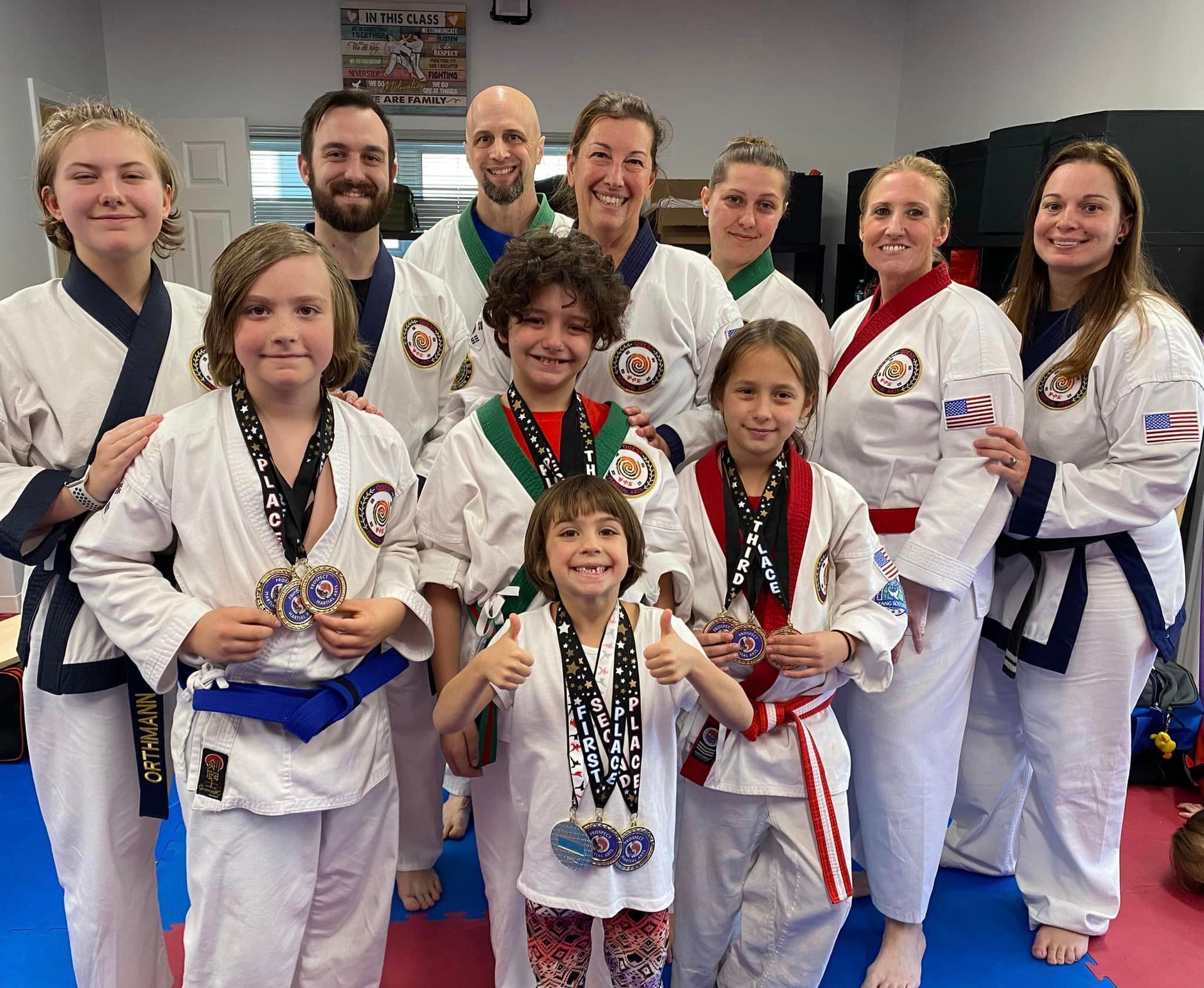 a group of people in karate uniforms are posing for a picture .