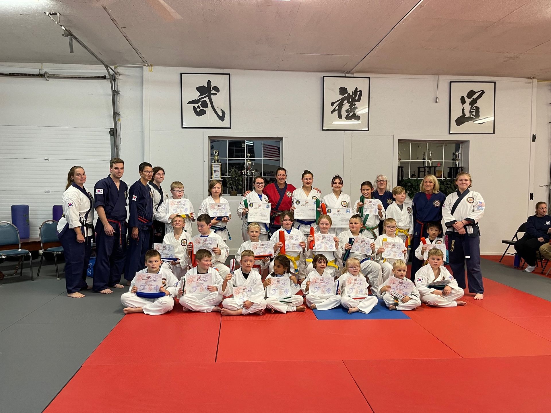 a group of people are posing for a picture in a gym .