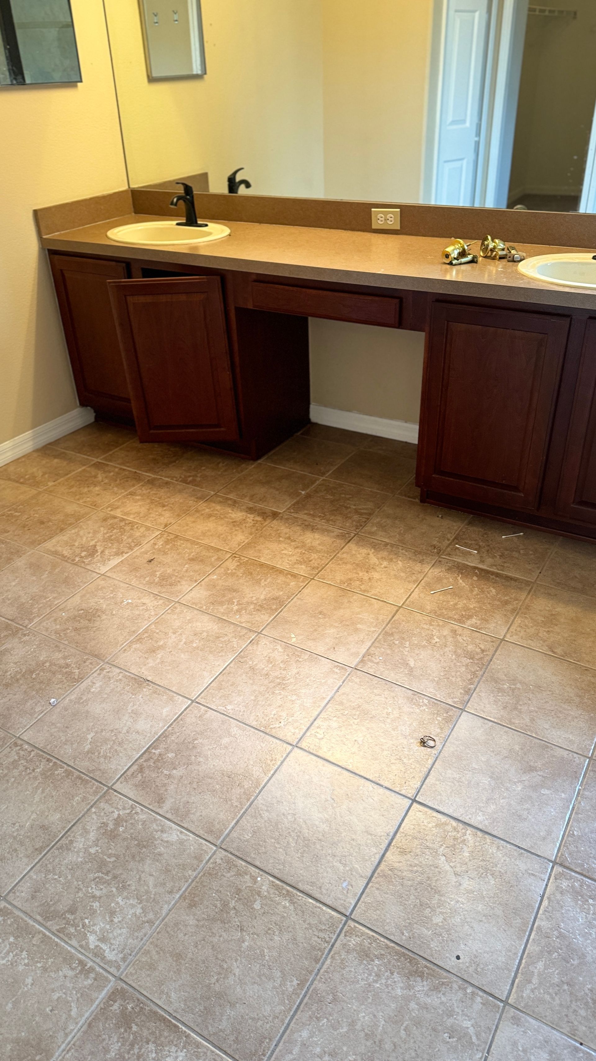 A bathroom with two sinks and a mirror.