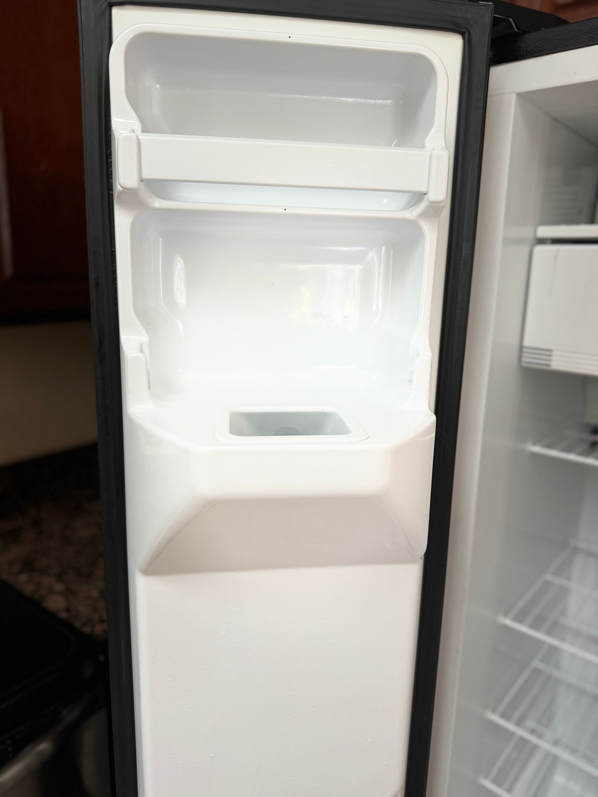 The inside of an empty refrigerator with the door open