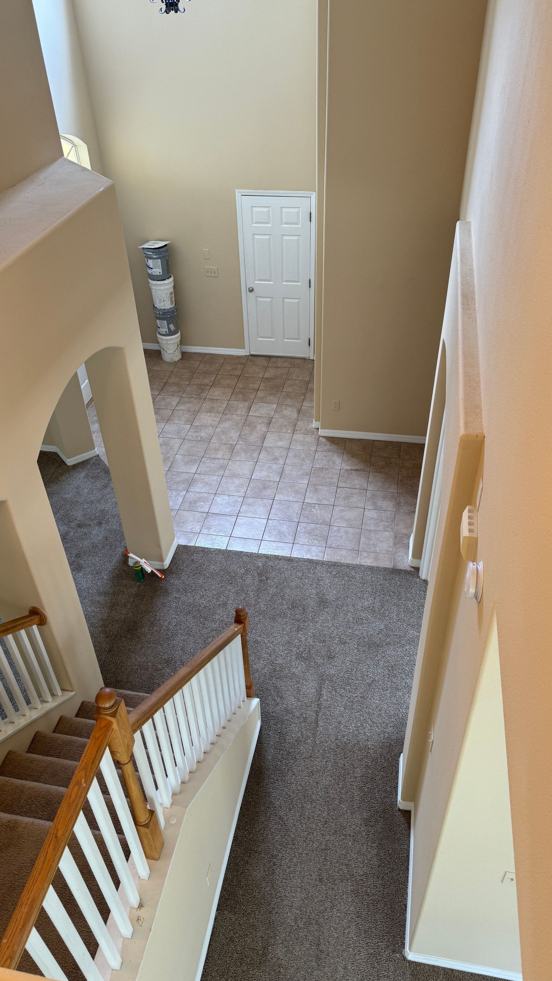 An aerial view of a house with stairs leading up to the second floor.