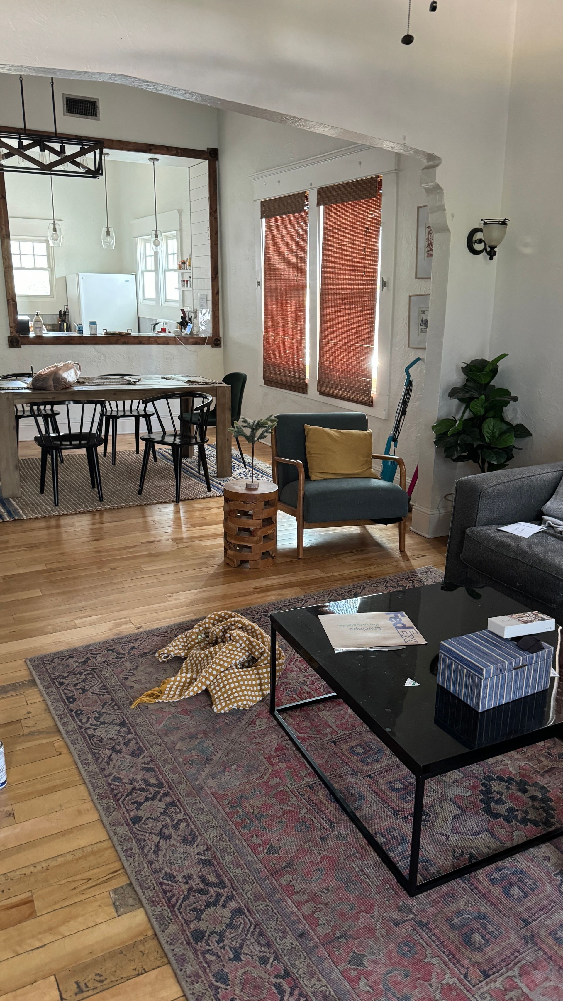 A living room with a couch , chair , coffee table and rug.