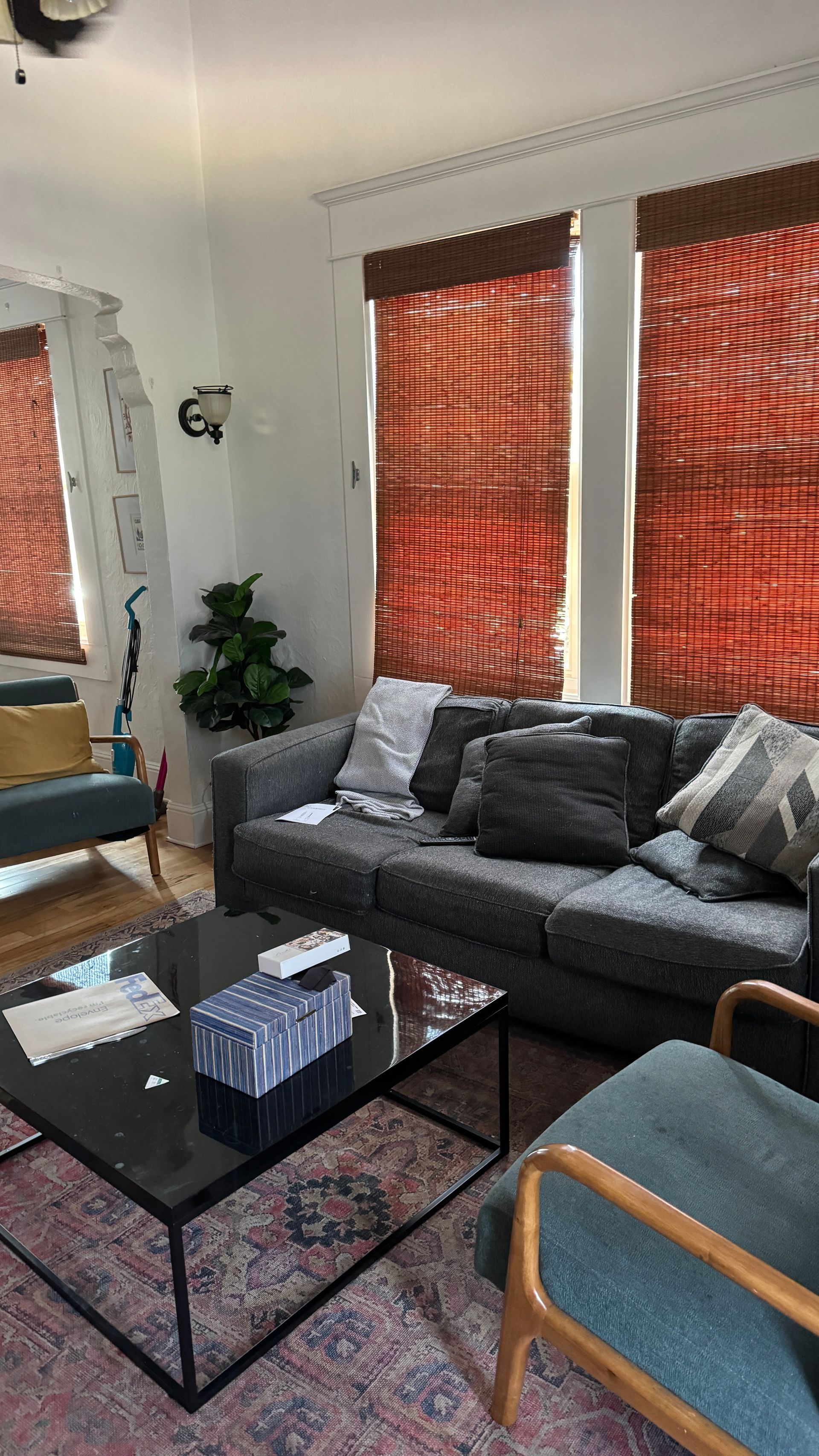 A living room with a couch , chairs , and a coffee table.