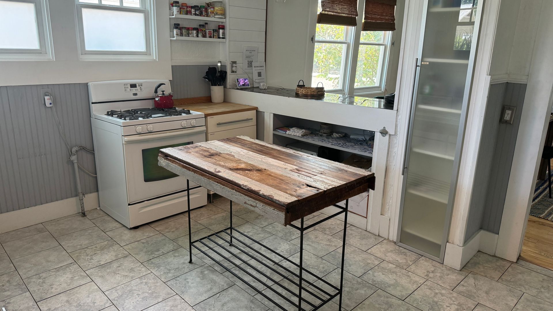 A kitchen with a wooden table and a stove.