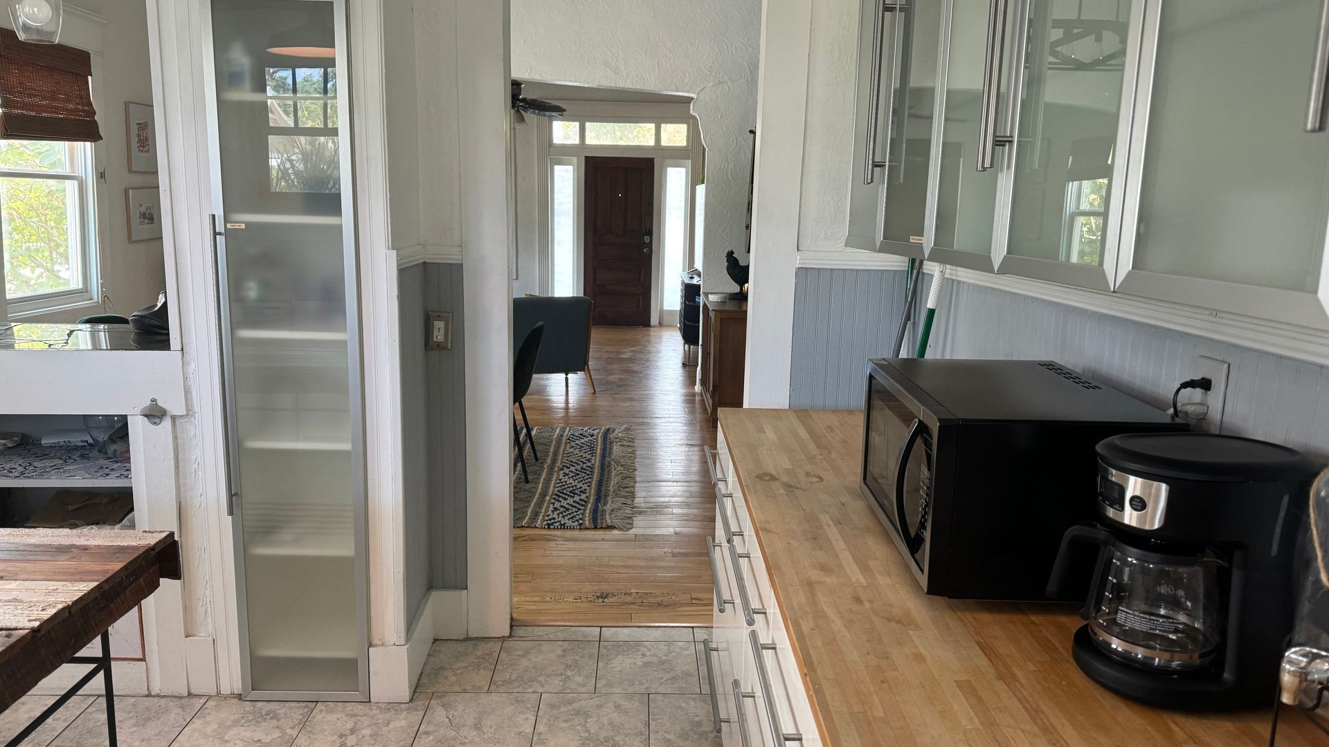 A kitchen with a microwave and coffee maker on the counter.