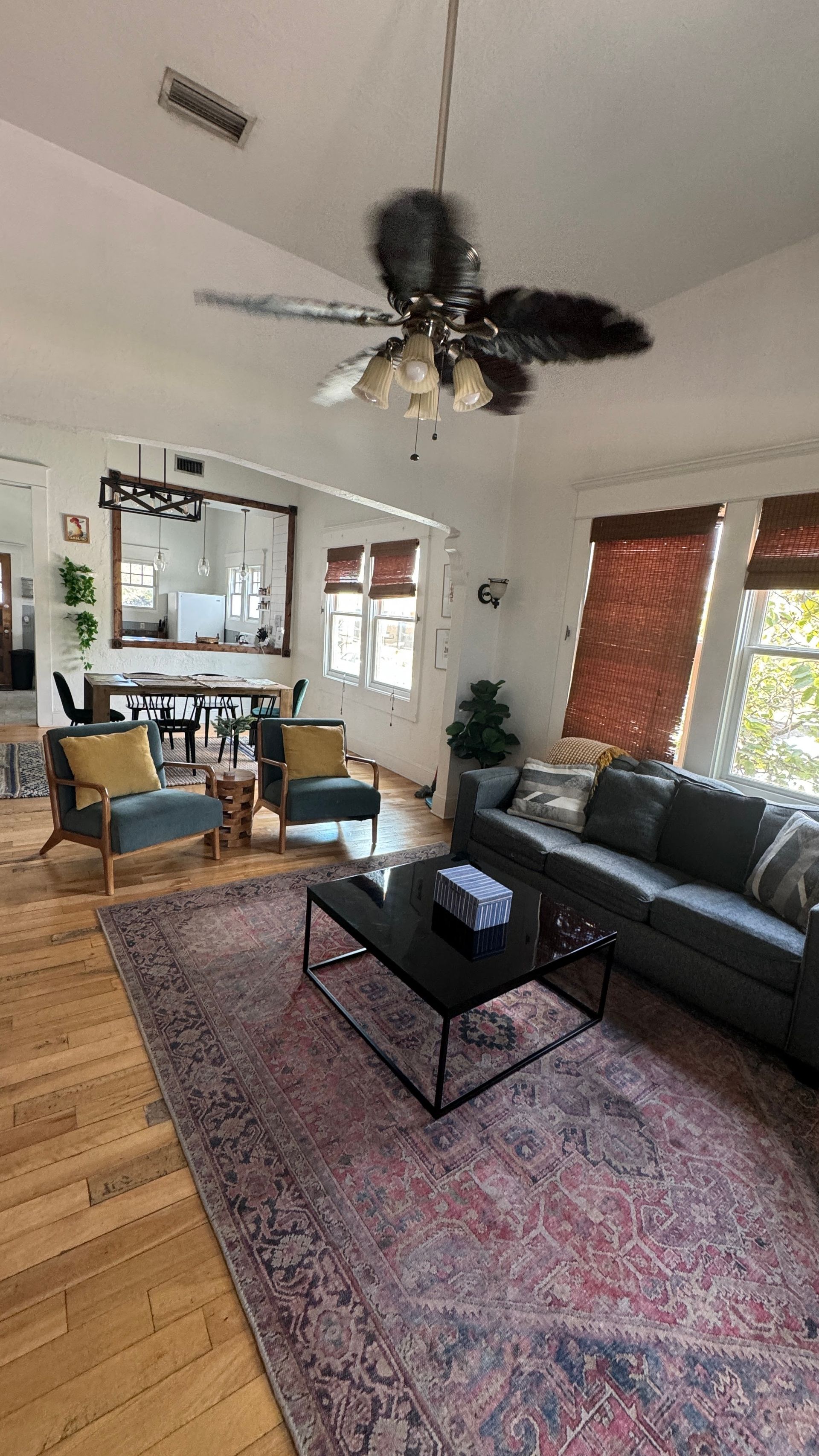 A living room filled with furniture and a ceiling fan.