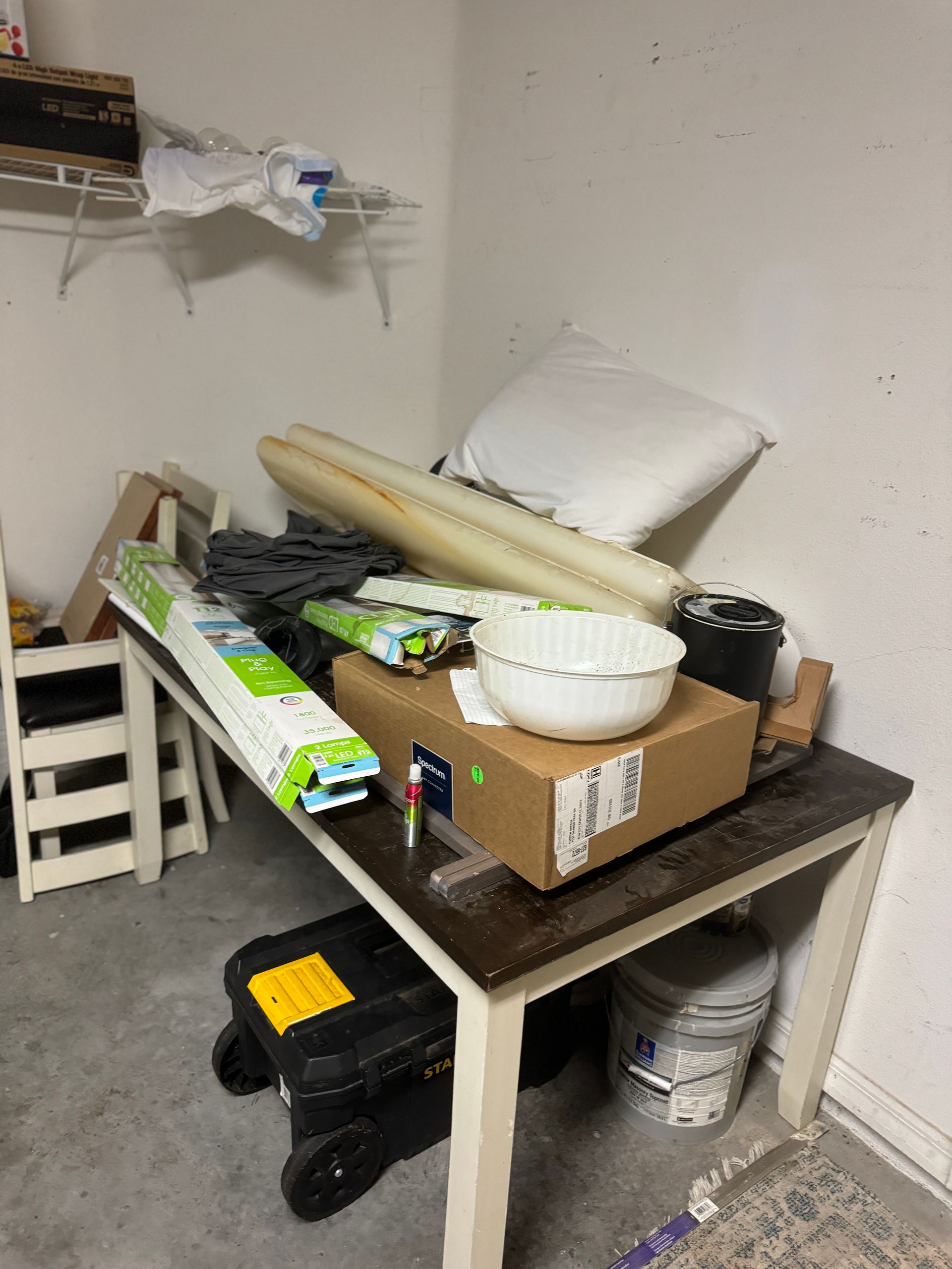 A messy room with a table and boxes on it
