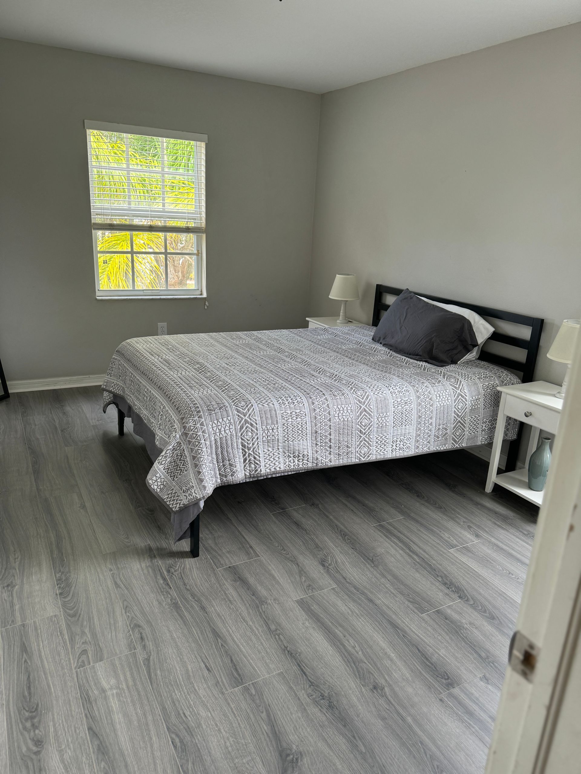 A bedroom with a large bed and a window
