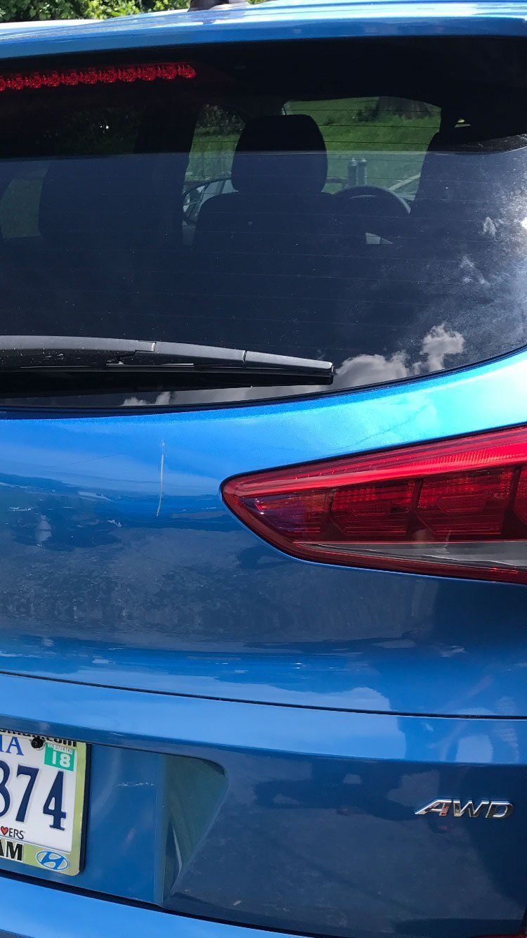 A blue car with a license plate that says 874