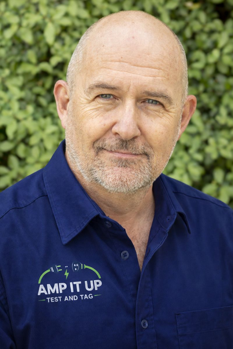 Bald man wearing a blue shirt with 