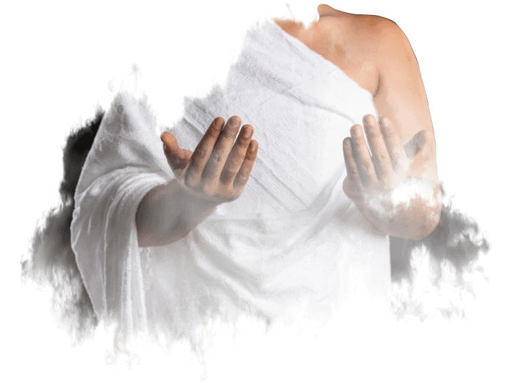 A man in a white robe is praying with his hands outstretched.