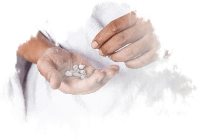 A doctor is holding a handful of pills in his hand.