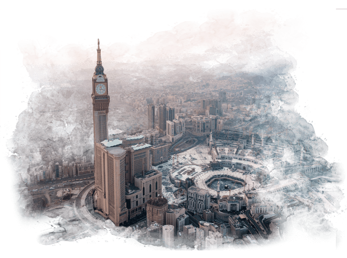 An aerial view of a city with a clock tower in the middle of it.