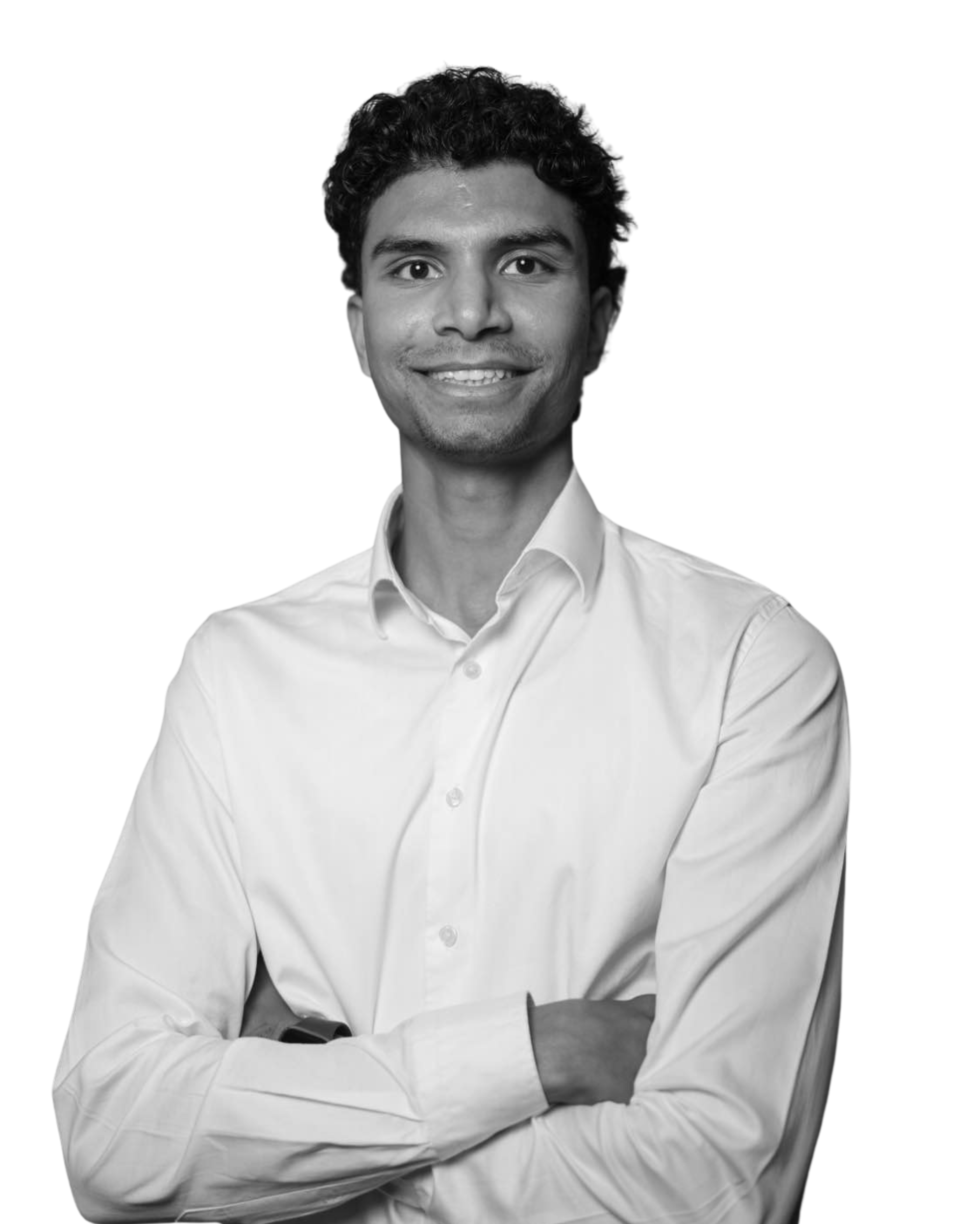 A man in a suit and tie is smiling in a black and white photo