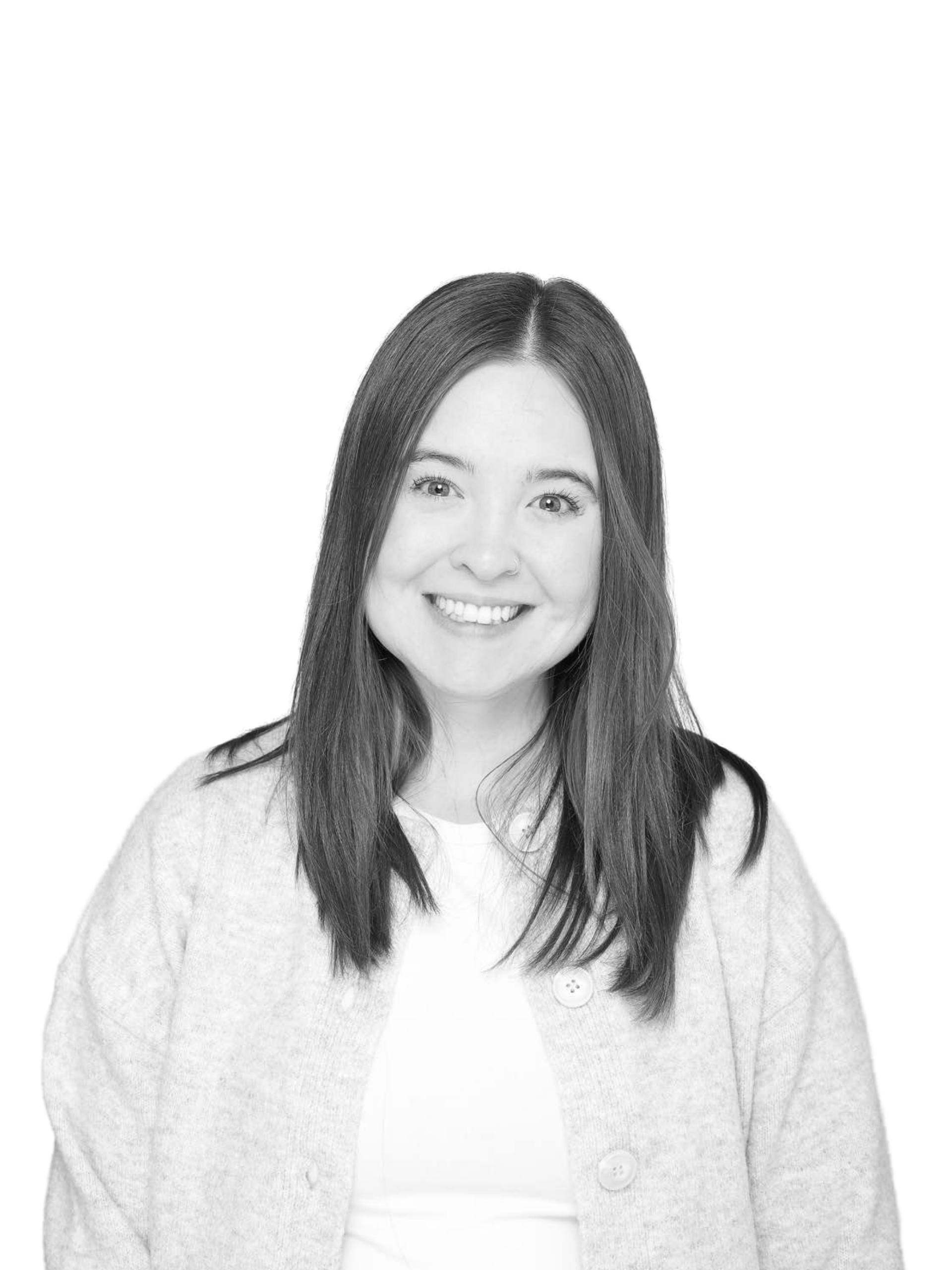 A black and white photo of a woman wearing a sweater and smiling.