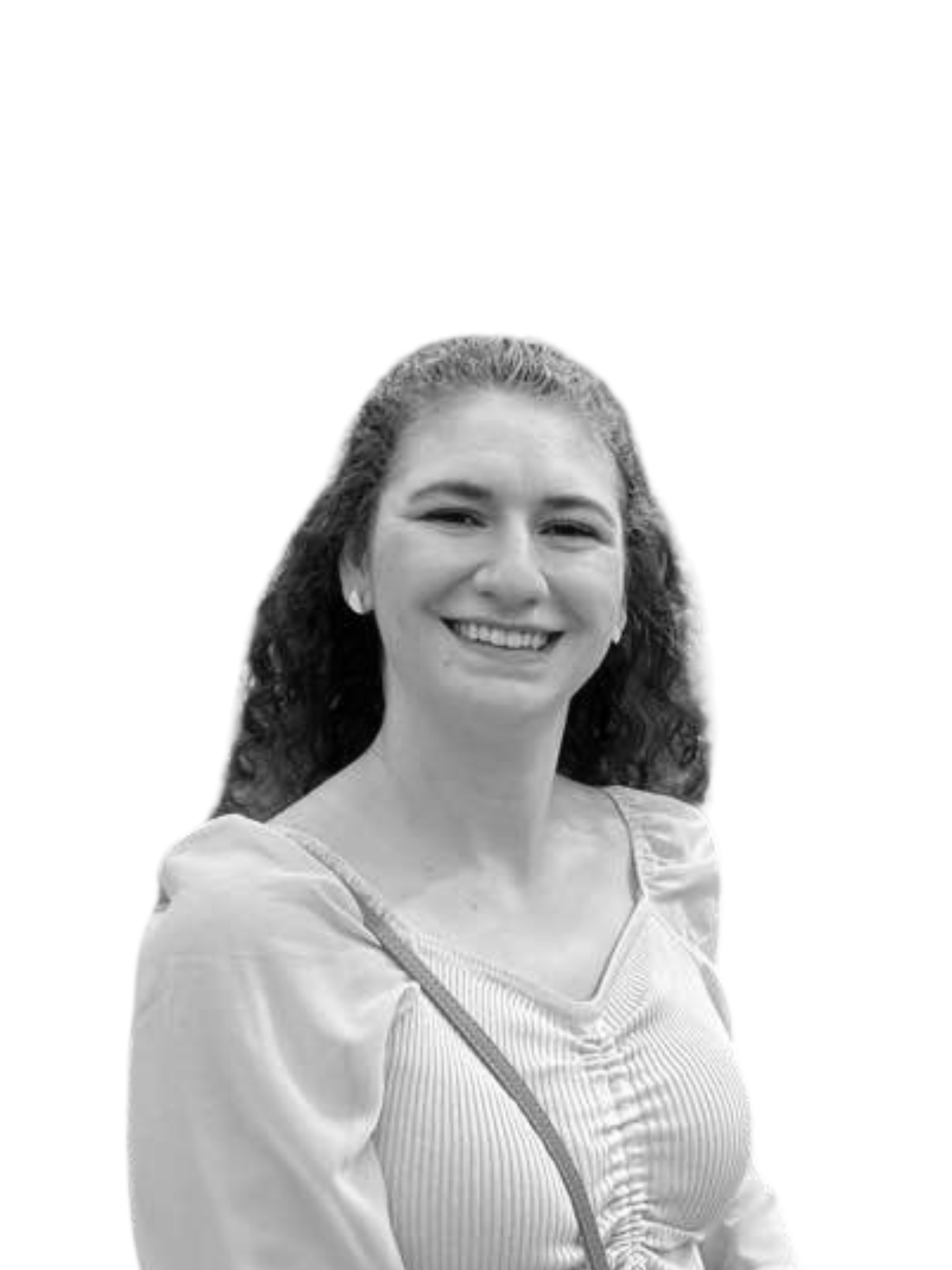 A black and white photo of a woman wearing a sweater and smiling.