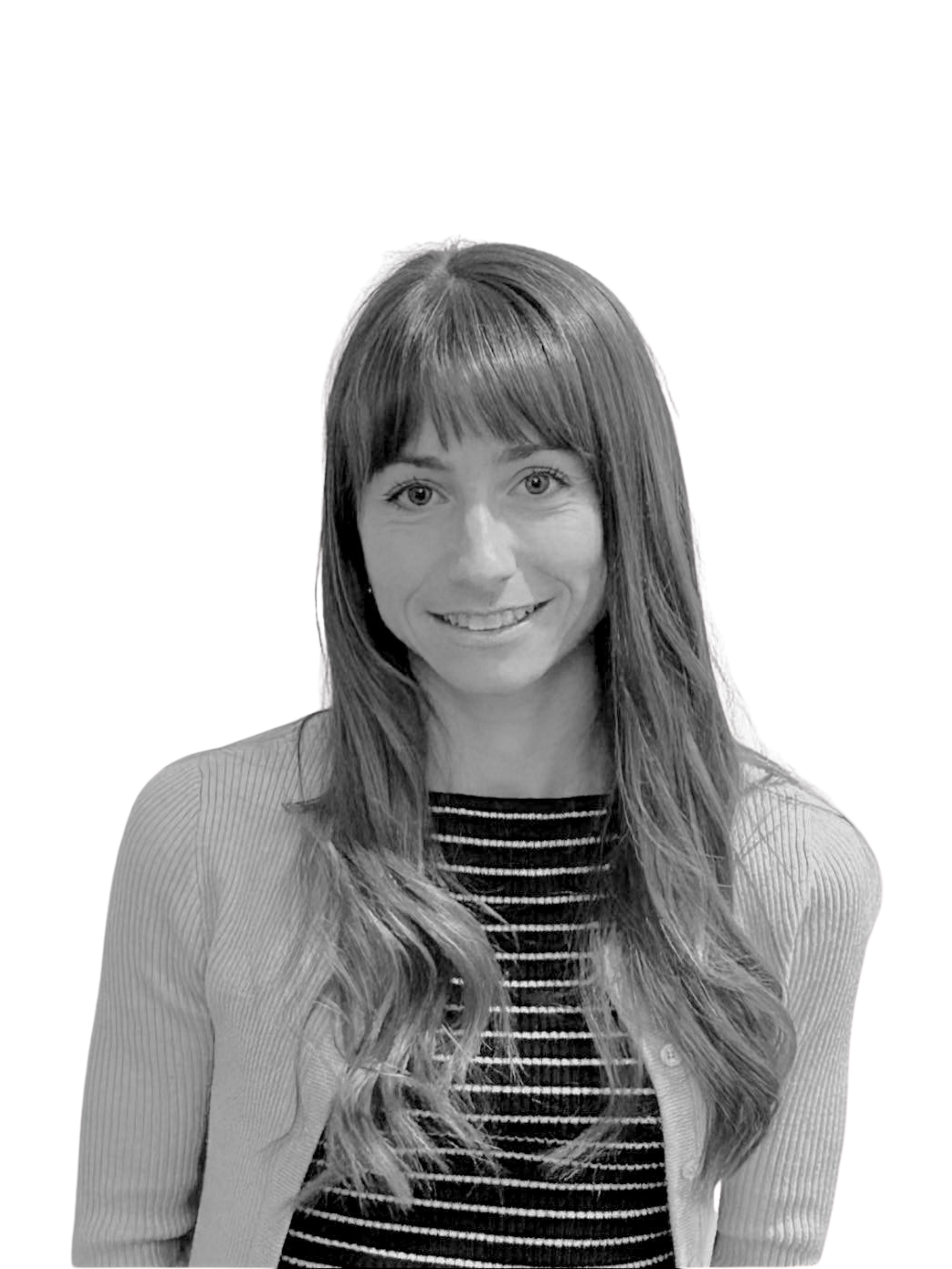 A woman with curly hair is smiling in a black and white photo.
