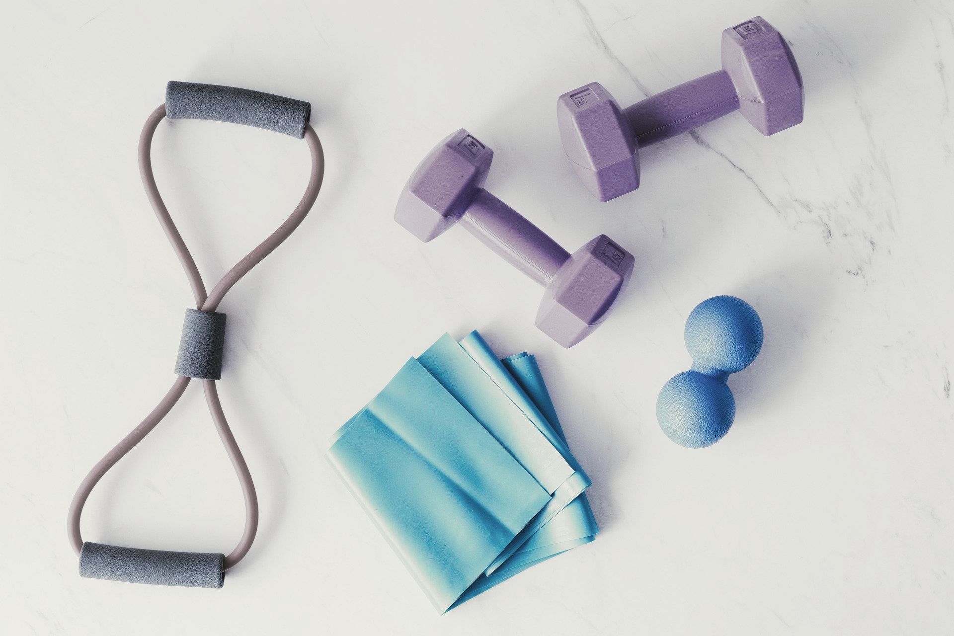 There are a lot of different types of exercise equipment on the table.