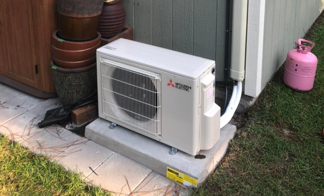 An Ameristar HVAC unit in a utility closet with exposed wiring.