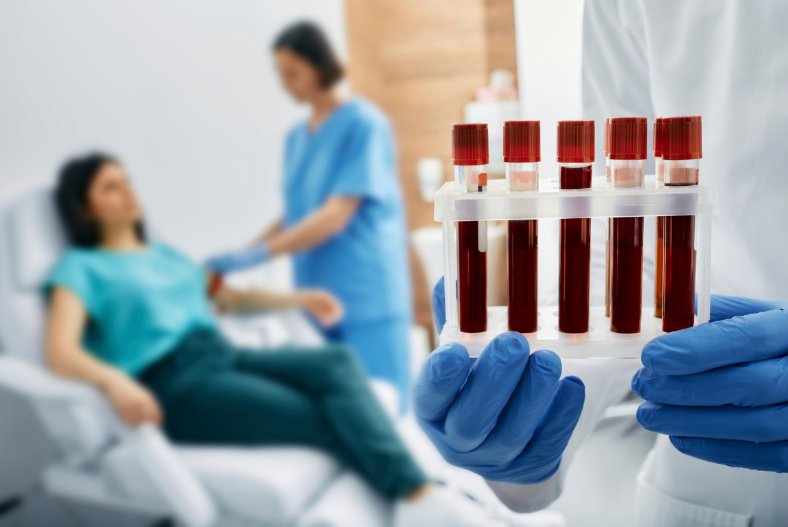 Person holding blood samples; nurse draws blood from patient in medical setting.