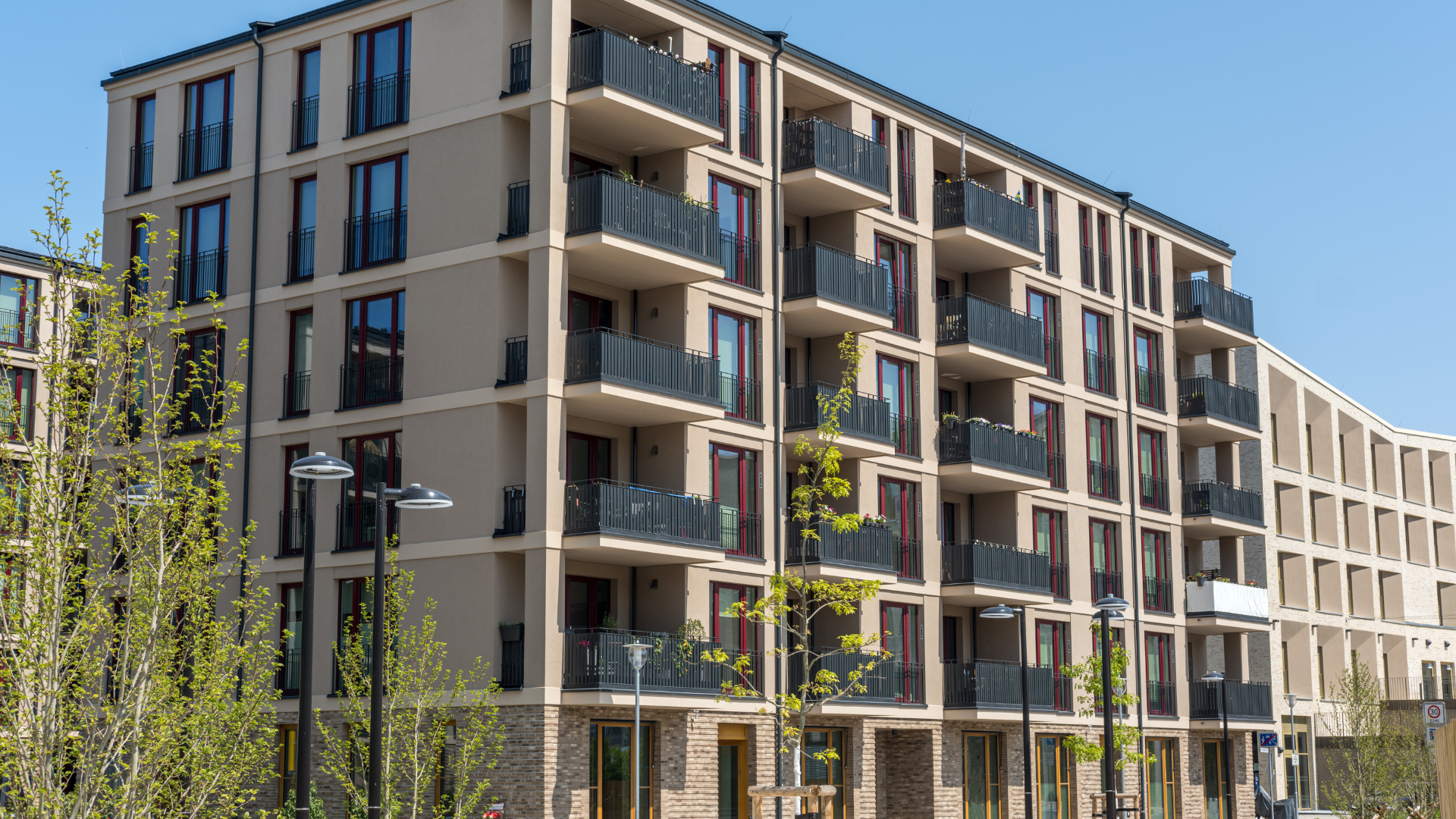 A large apartment building with a lot of windows and balconies.