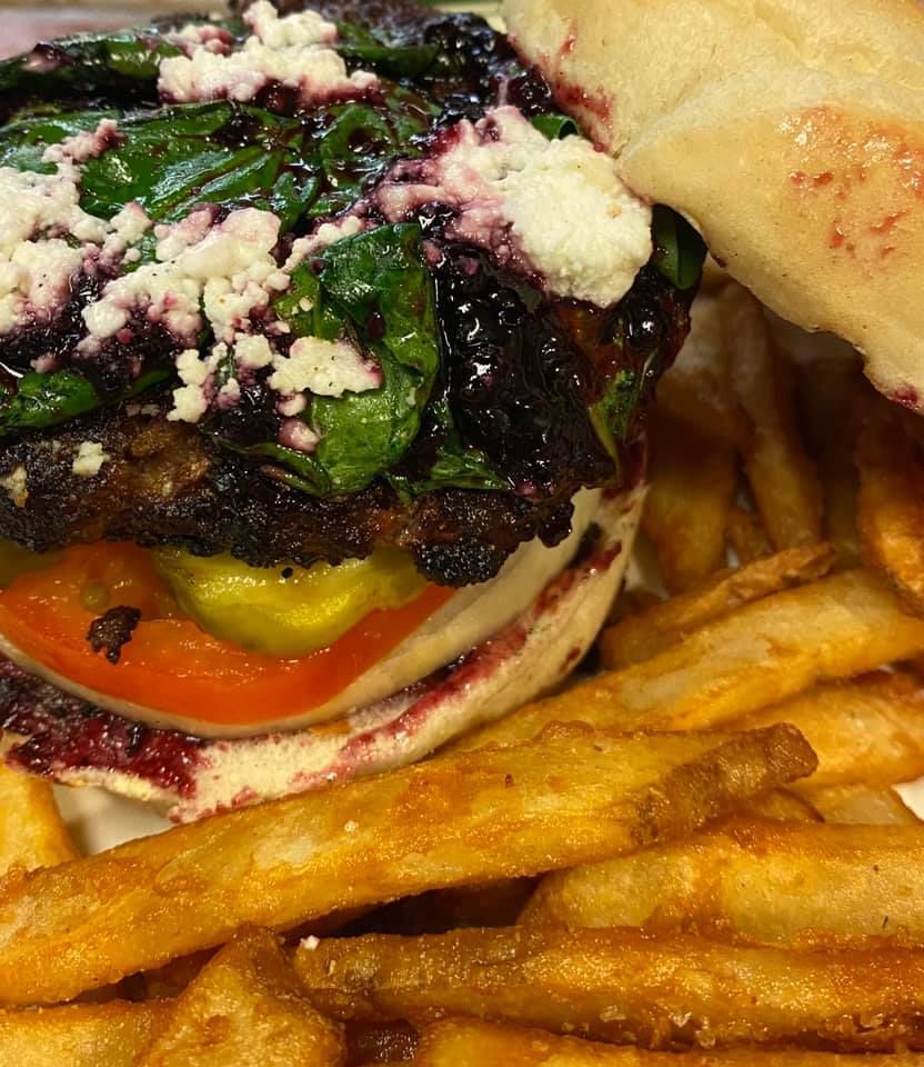 A close up of a sandwich and french fries on a plate