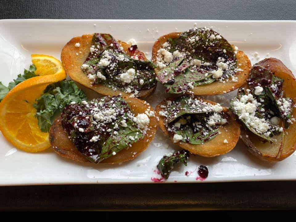 A white plate topped with a variety of vegetables and cheese.