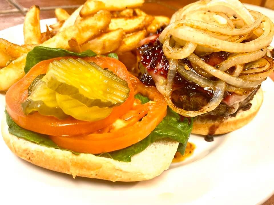 A white plate topped with a hamburger and french fries
