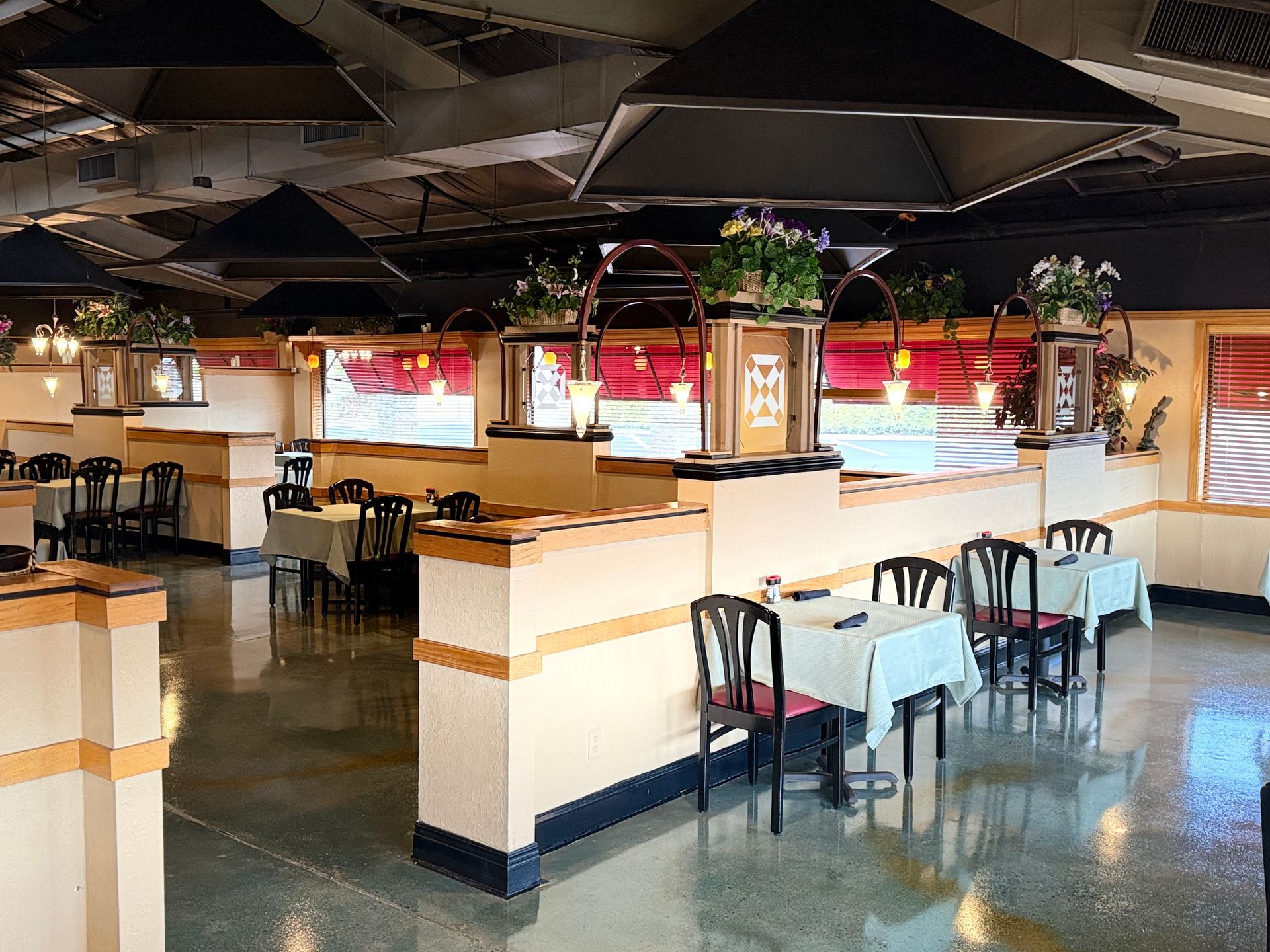 A restaurant with tables and chairs and a sign that says 100