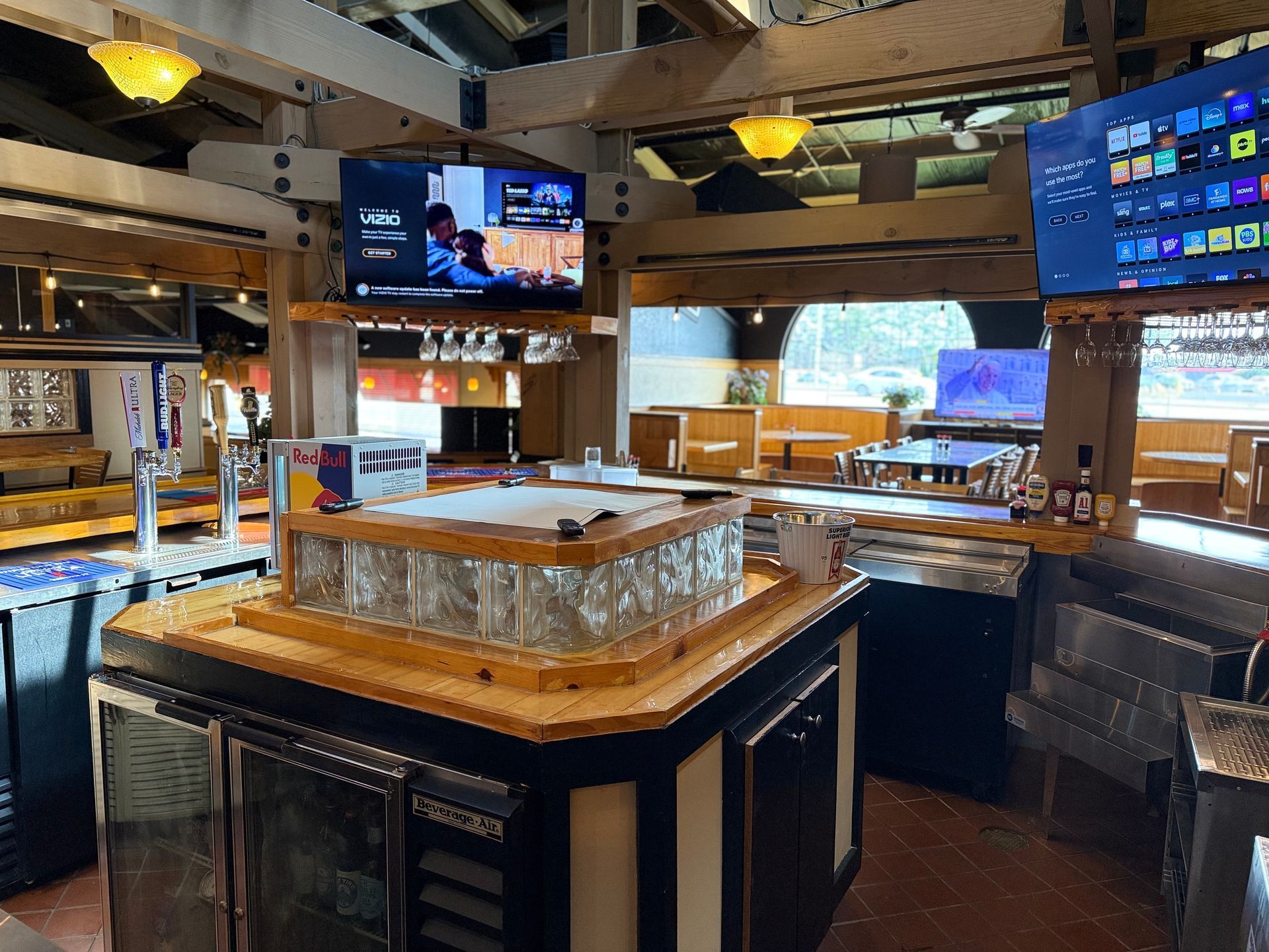 A restaurant with a bar and a television on the wall