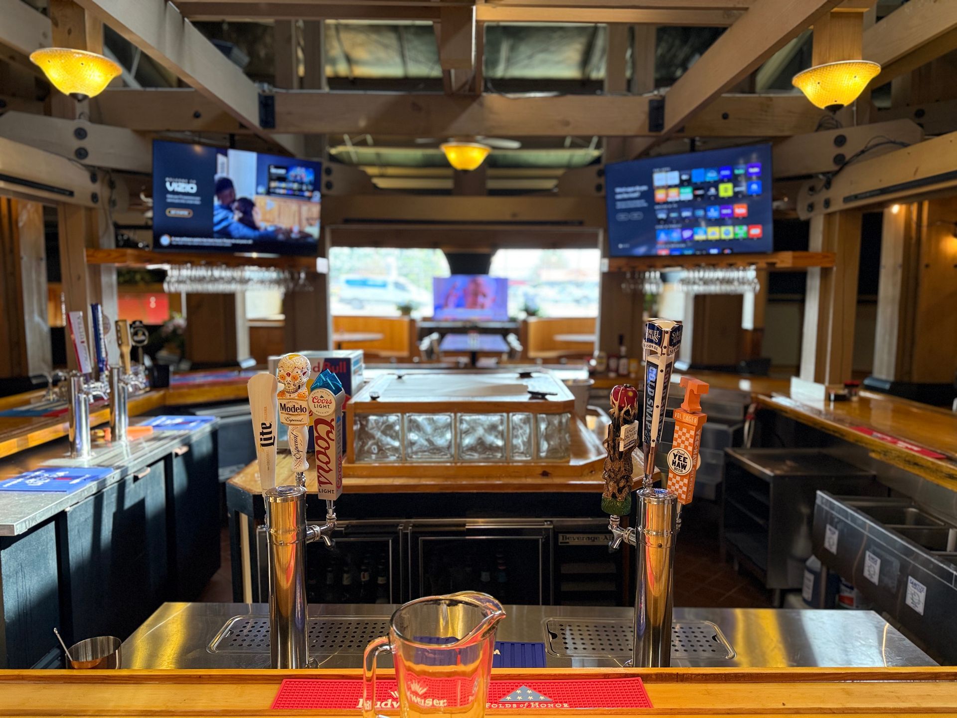A bar with a pitcher of beer on the counter