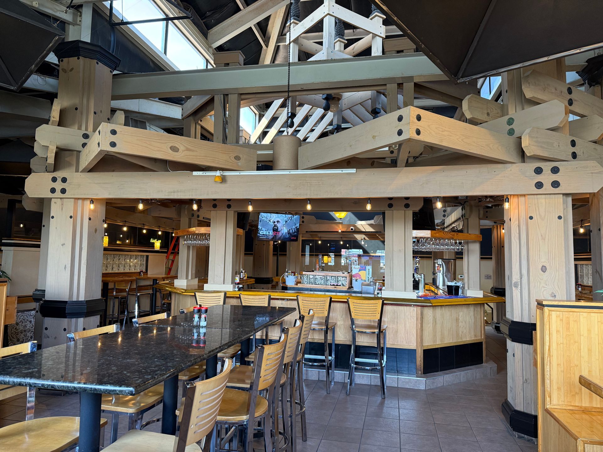 A restaurant with tables and chairs and a bar