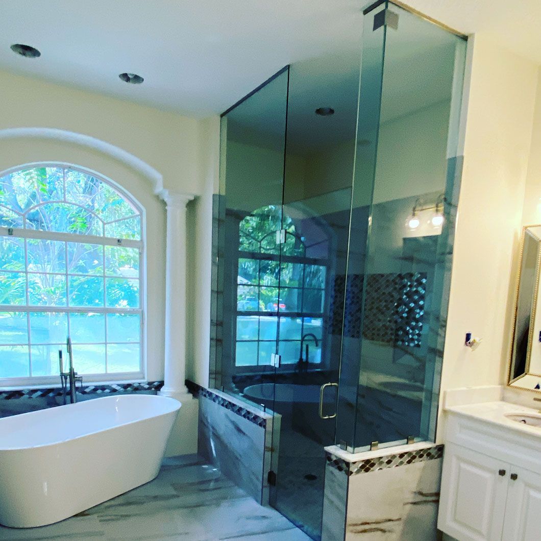 A bathroom with a bathtub and a walk in shower