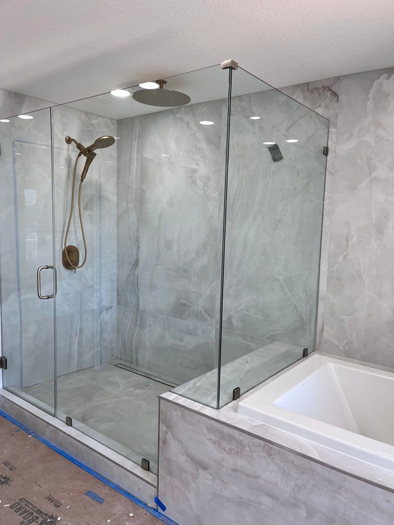 A bathroom with a walk in shower and a bathtub.