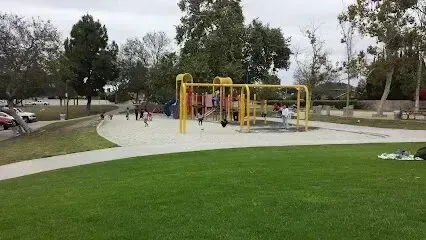 Window Tinting Service-A group of children are playing in a playground in a park.