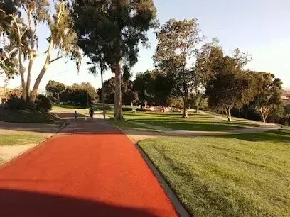 Window Tinting Service-A red path in a park with trees and grass