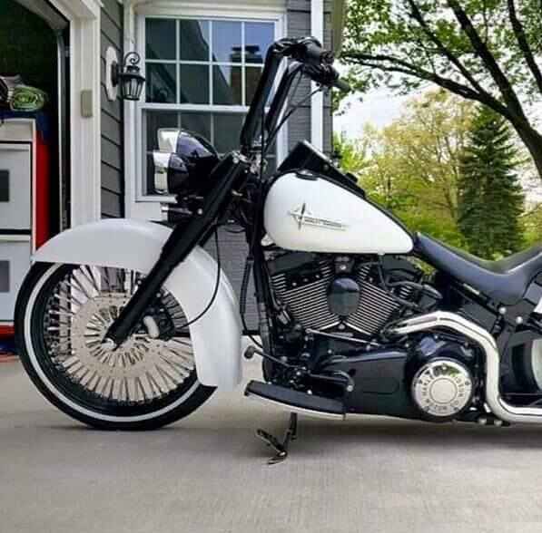 A Harley Davidson Motorcycle is Parked in Front of a House — Skids Mechanical Services Pty Ltd in Wagga Wagga, NSW