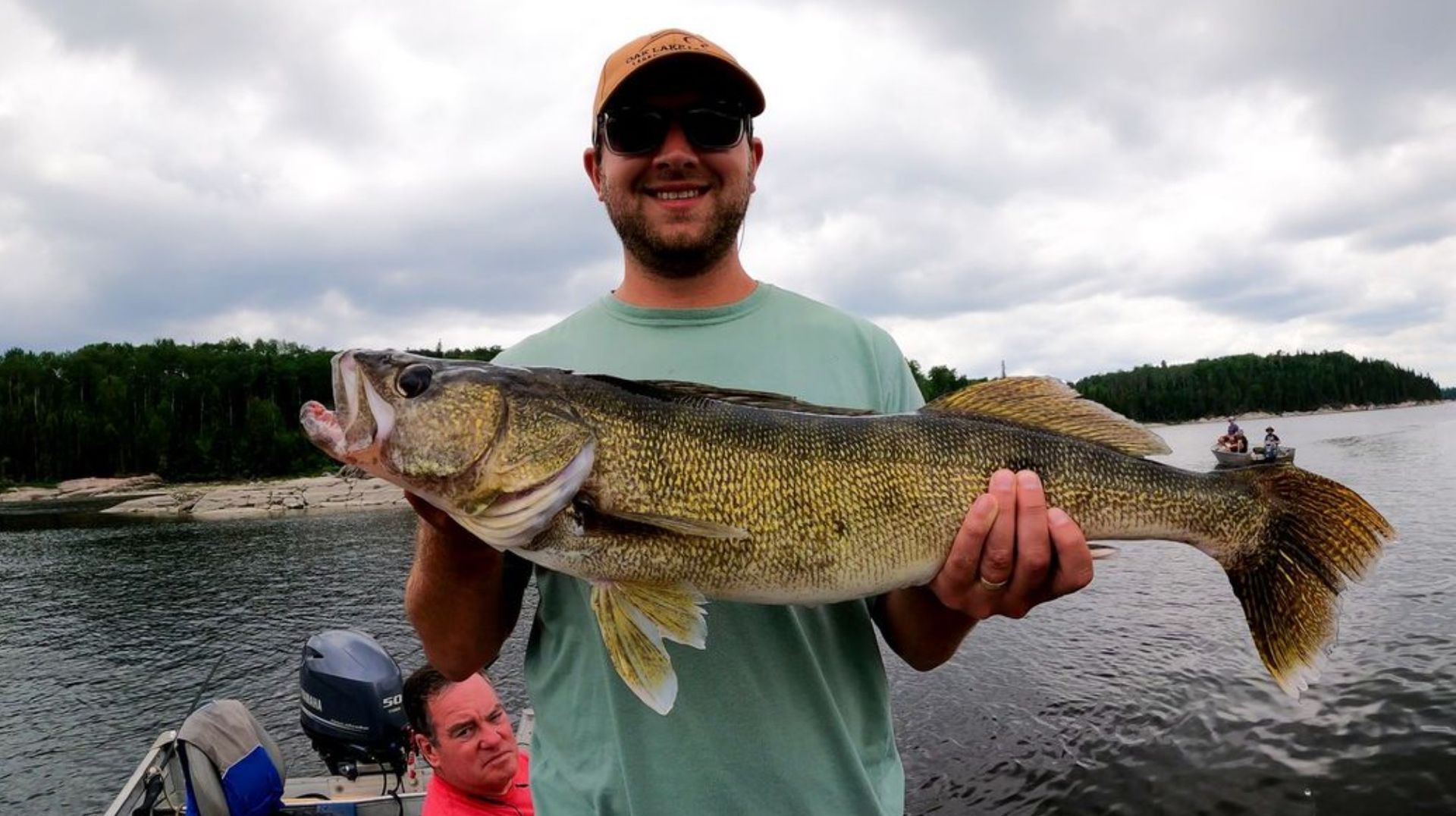 A son holding up a 31 inch walleye on a father and son trip to Oak Lake Lodge.