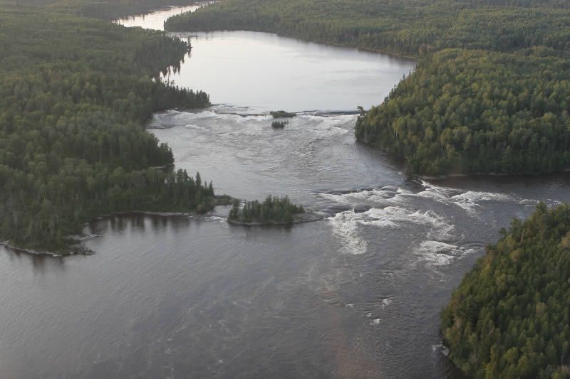 An aerial view of a large body of water surrounded by trees.