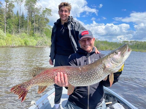 John holding the northern pike fish he caught at Oak Lake Lodge.