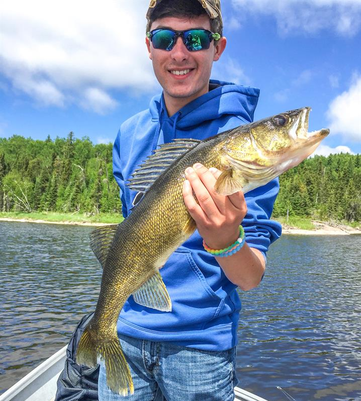 Young man goes walleye fishing in Ontario, Canada.