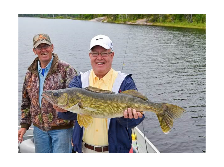 Fisherman at Oak lake Lodge in Canada holding a walleye