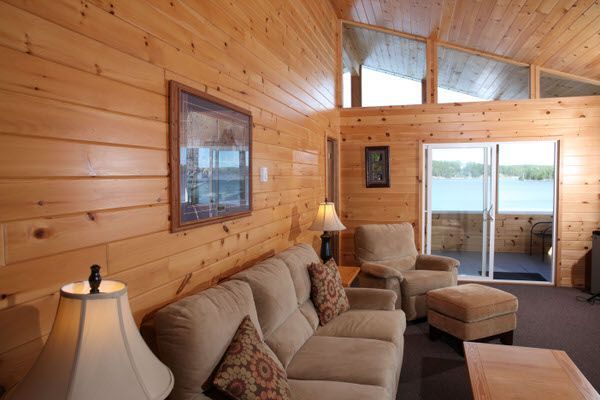 A living room with a couch and chairs and a sliding glass door
