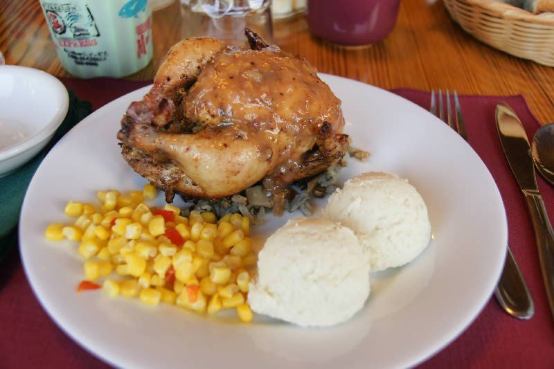Chicken dinner with potatoes and corn.